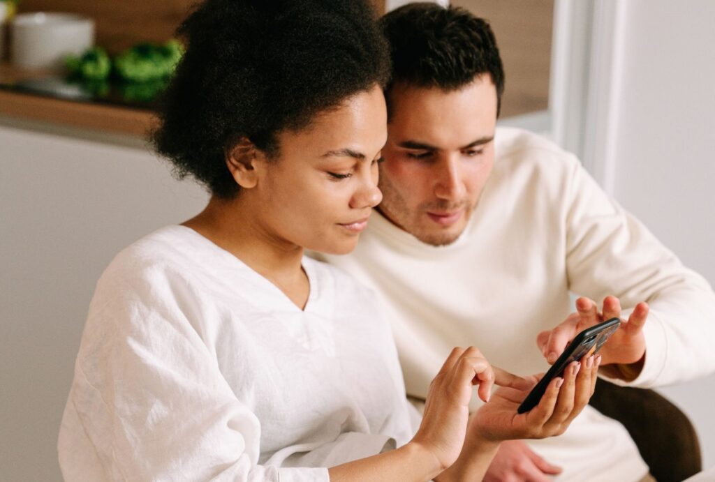 Couple reading finances on their phone together